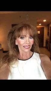 Barbara Pappas smiling in a white top.